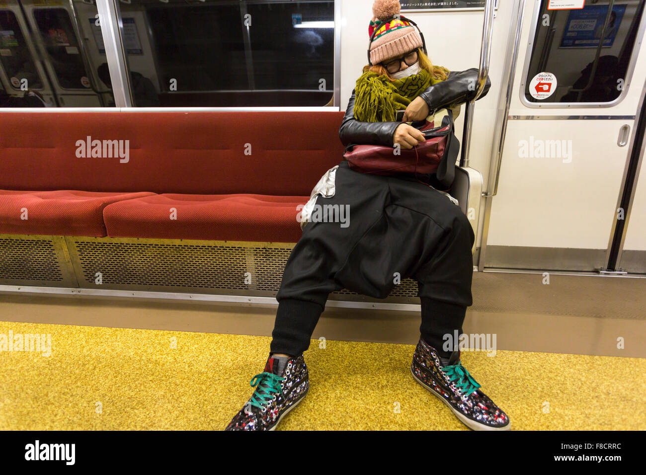 Unidentified Fashion Man sleeping in Tokyo metro Stock Photo