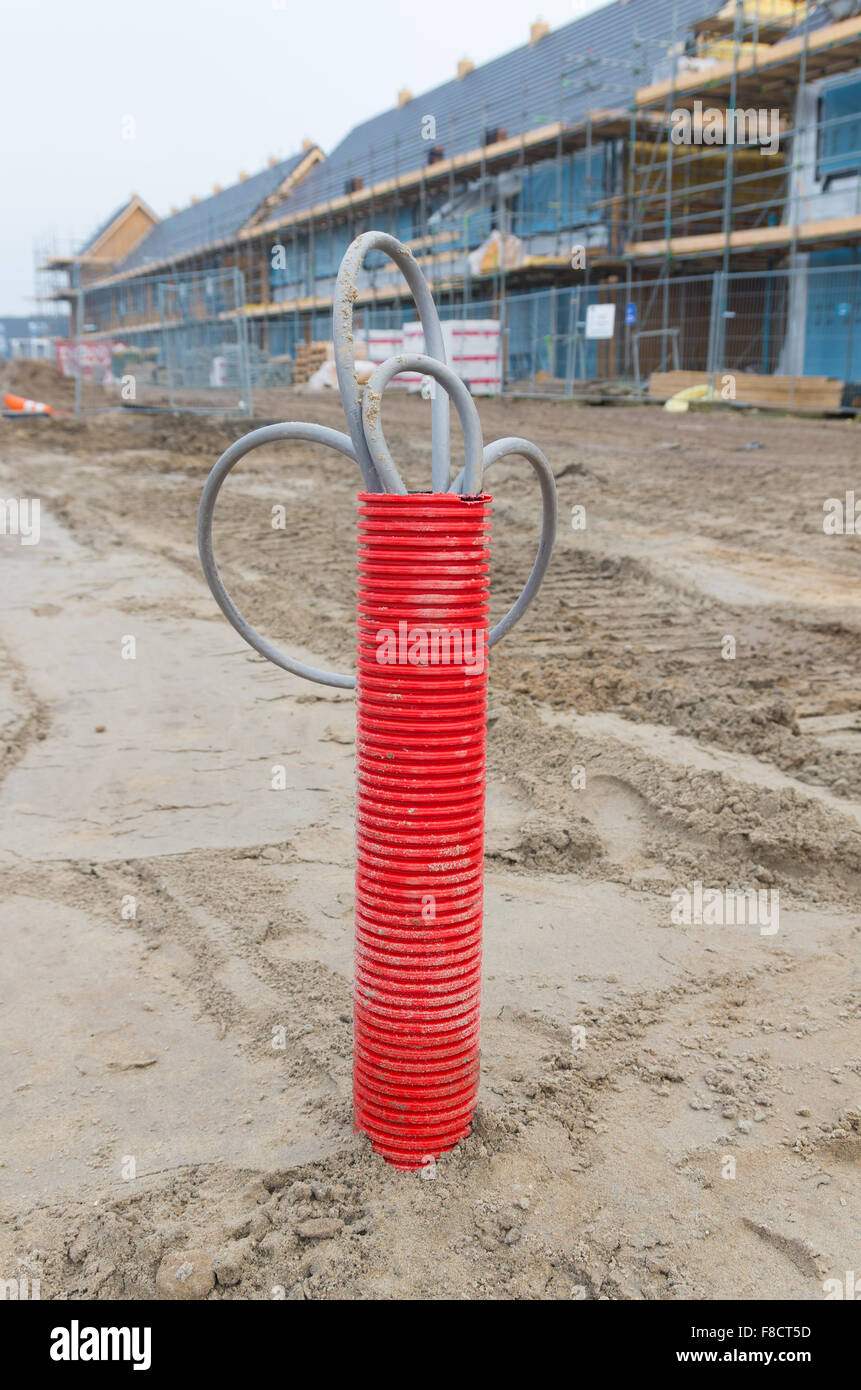 red plastic pipe with electricity cables on a construction site Stock Photo