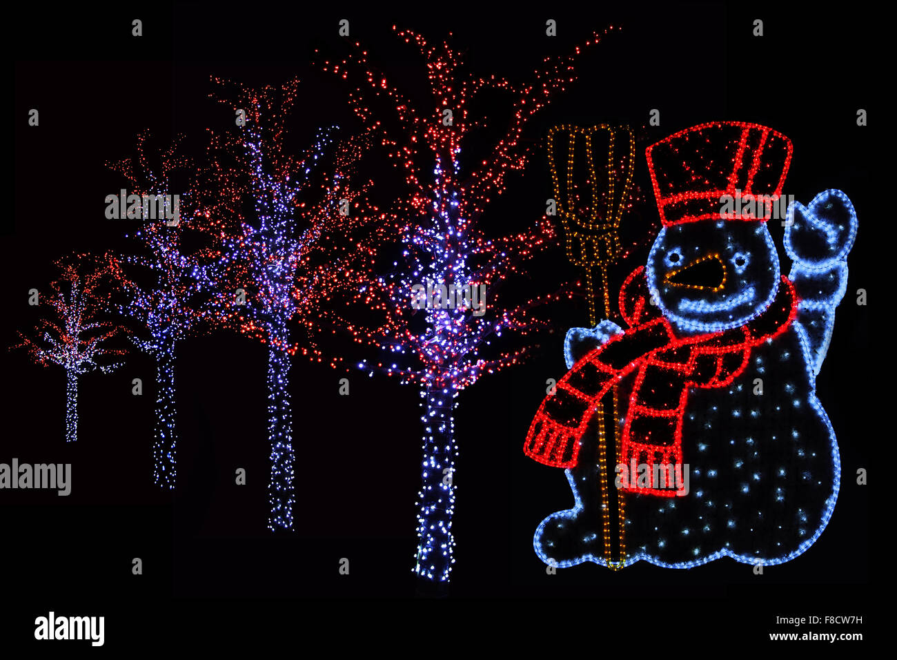 Outdoor night shot of Illuminated trees and Snowman for the perfect Christmas atmosphere Stock Photo