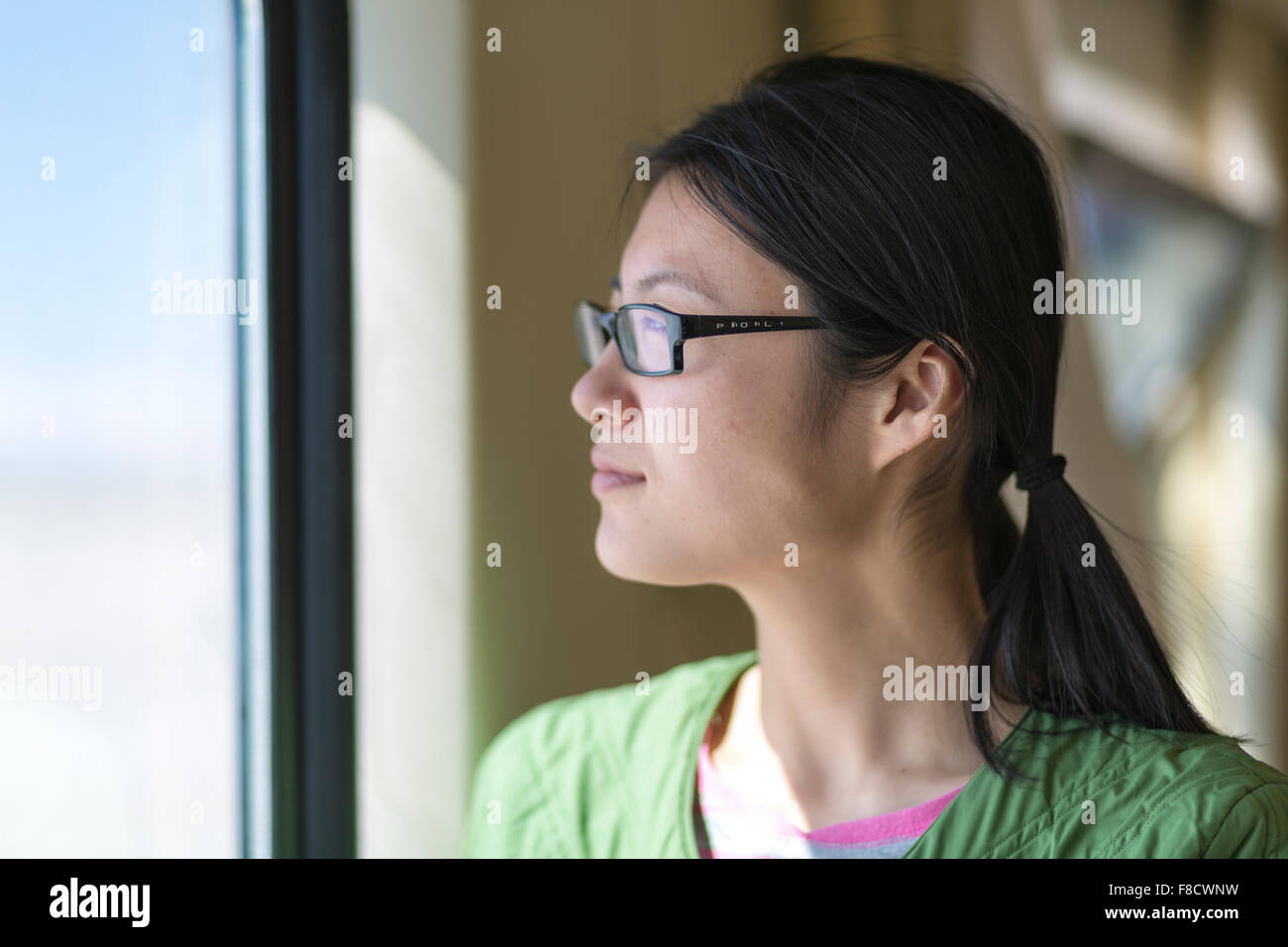 Beautiful woman looking through the window of a Train Stock Photo