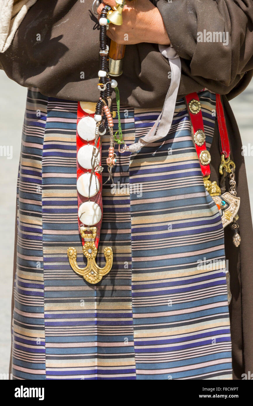 Tibetan fabrics and accessories on a Tibetan woman in Lhasa Stock Photo