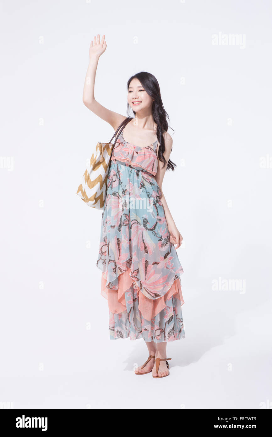 Woman With Long Hair In Maxi Dress Standing And Putting One Hand