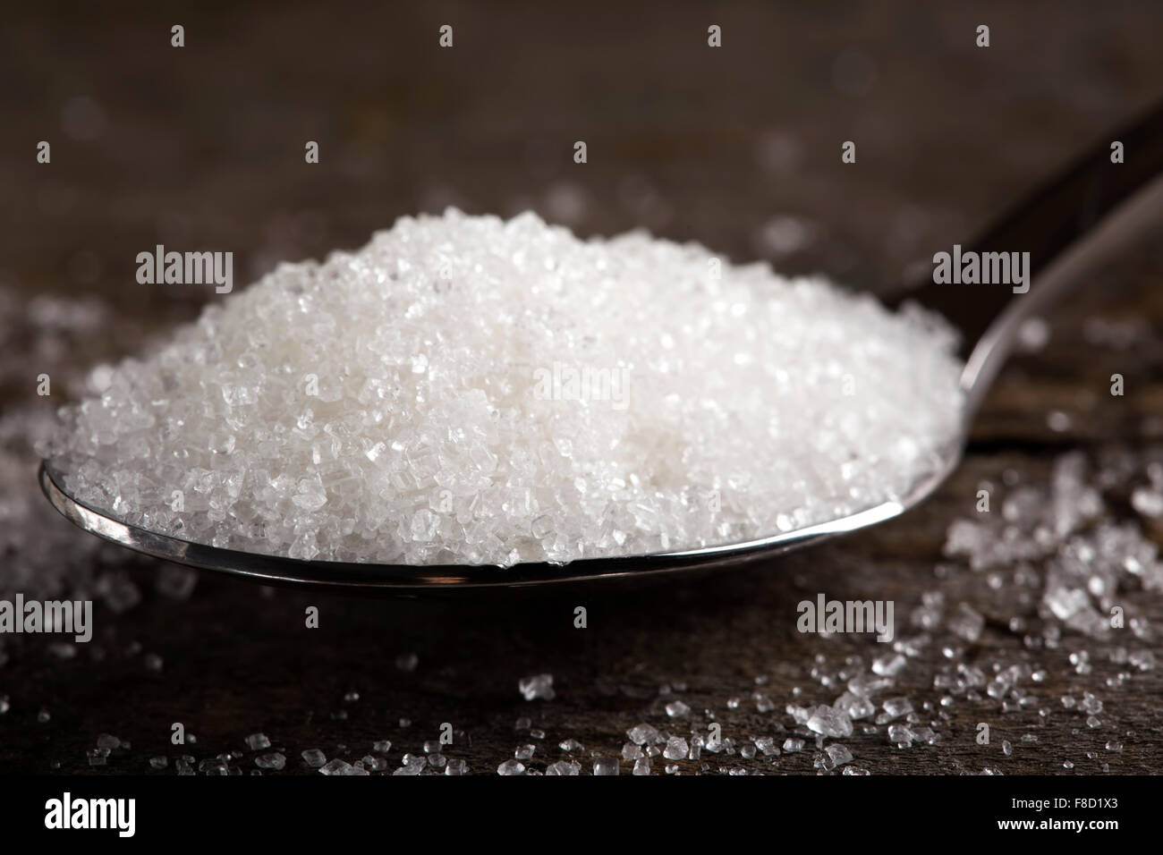 Close up of one spoon filled with sugar Stock Photo