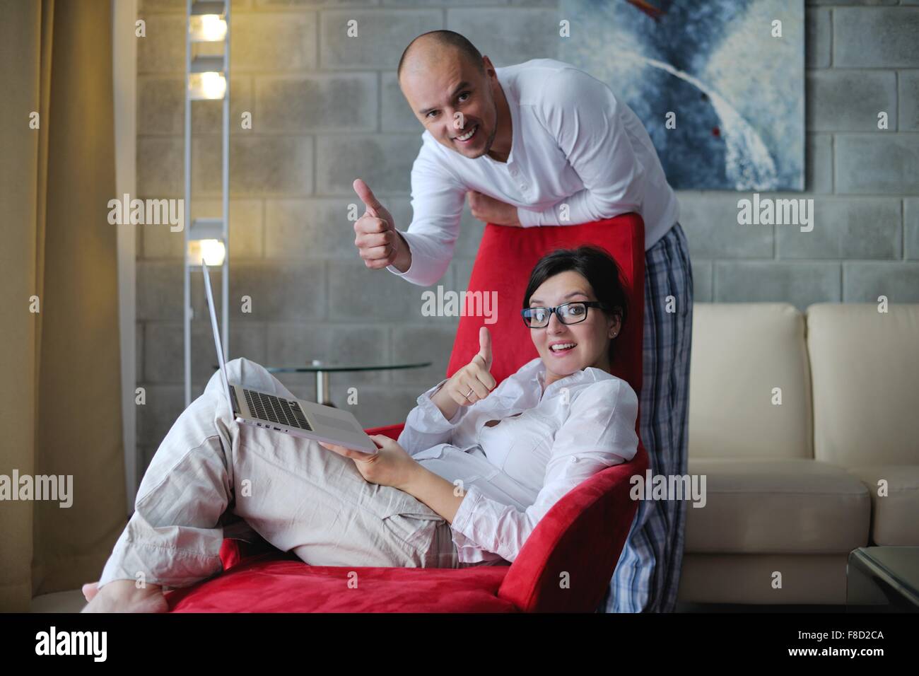 happy young Couple Using Laptop computer At Home Stock Photo - Alamy