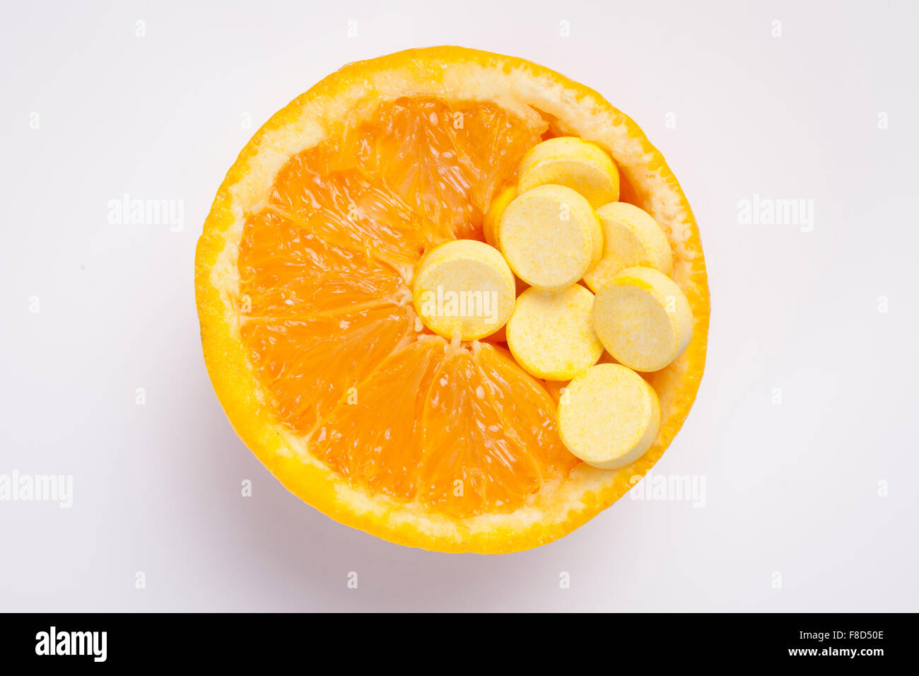High angle of cross section of orange and vitamin pills Stock Photo