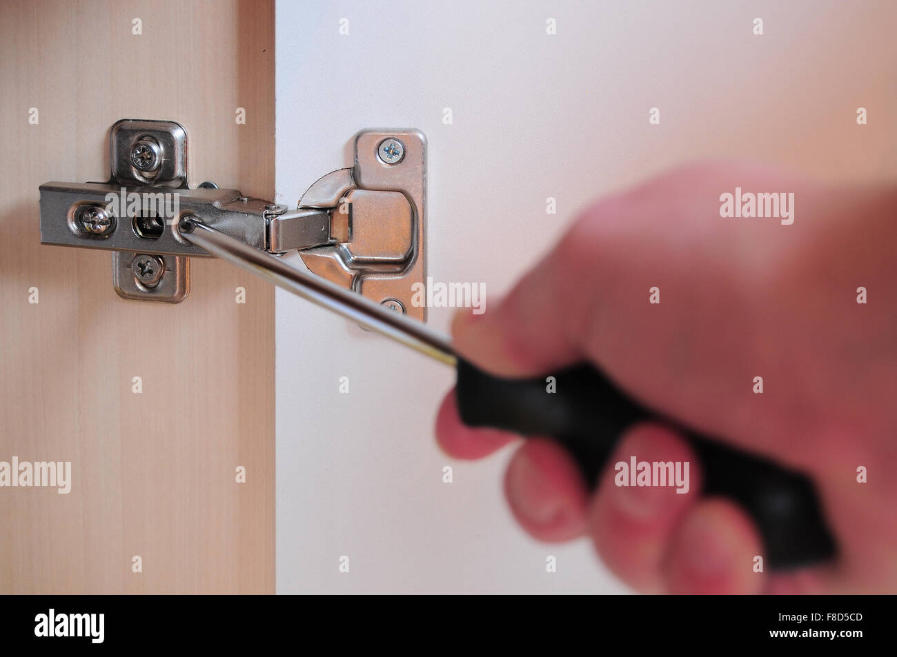 Man S Hand Holding A Screwdriver And Making An Adjustment To A