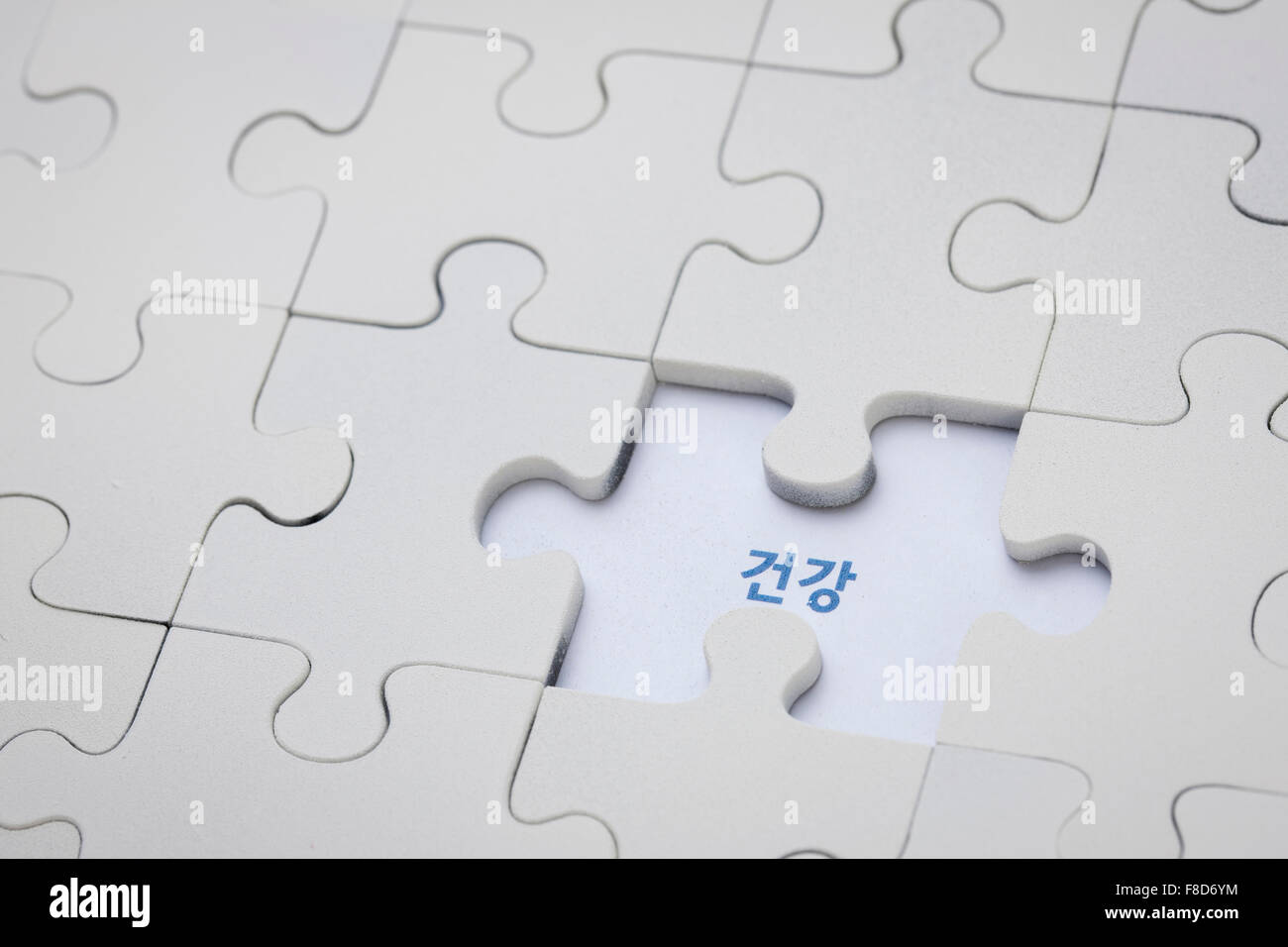 White puzzles without one piece and word meaning Health in Korean written  in the place Stock Photo - Alamy