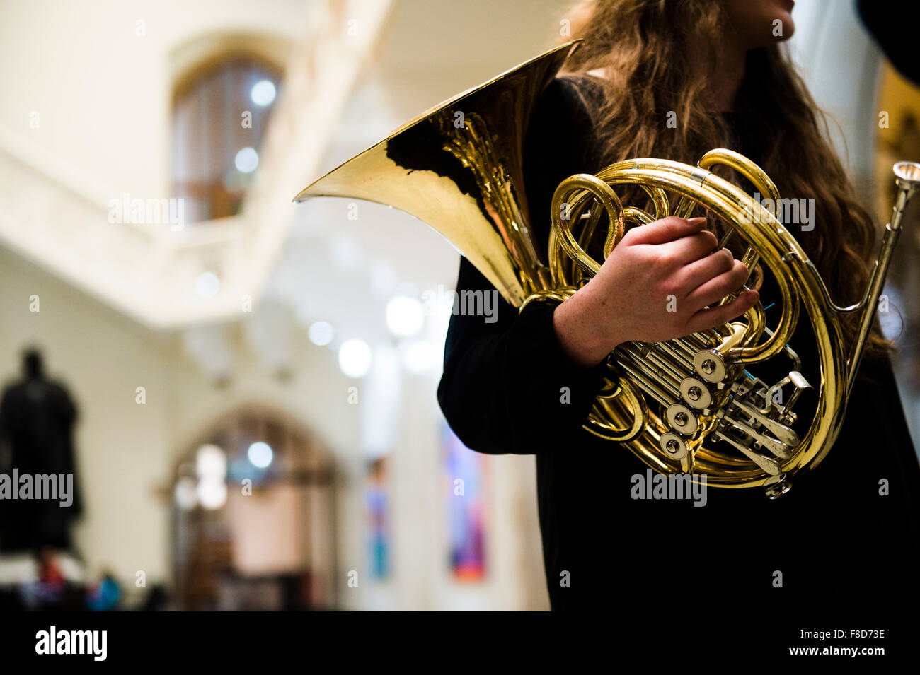 Young musicians classical music french horn player in rehearsal at