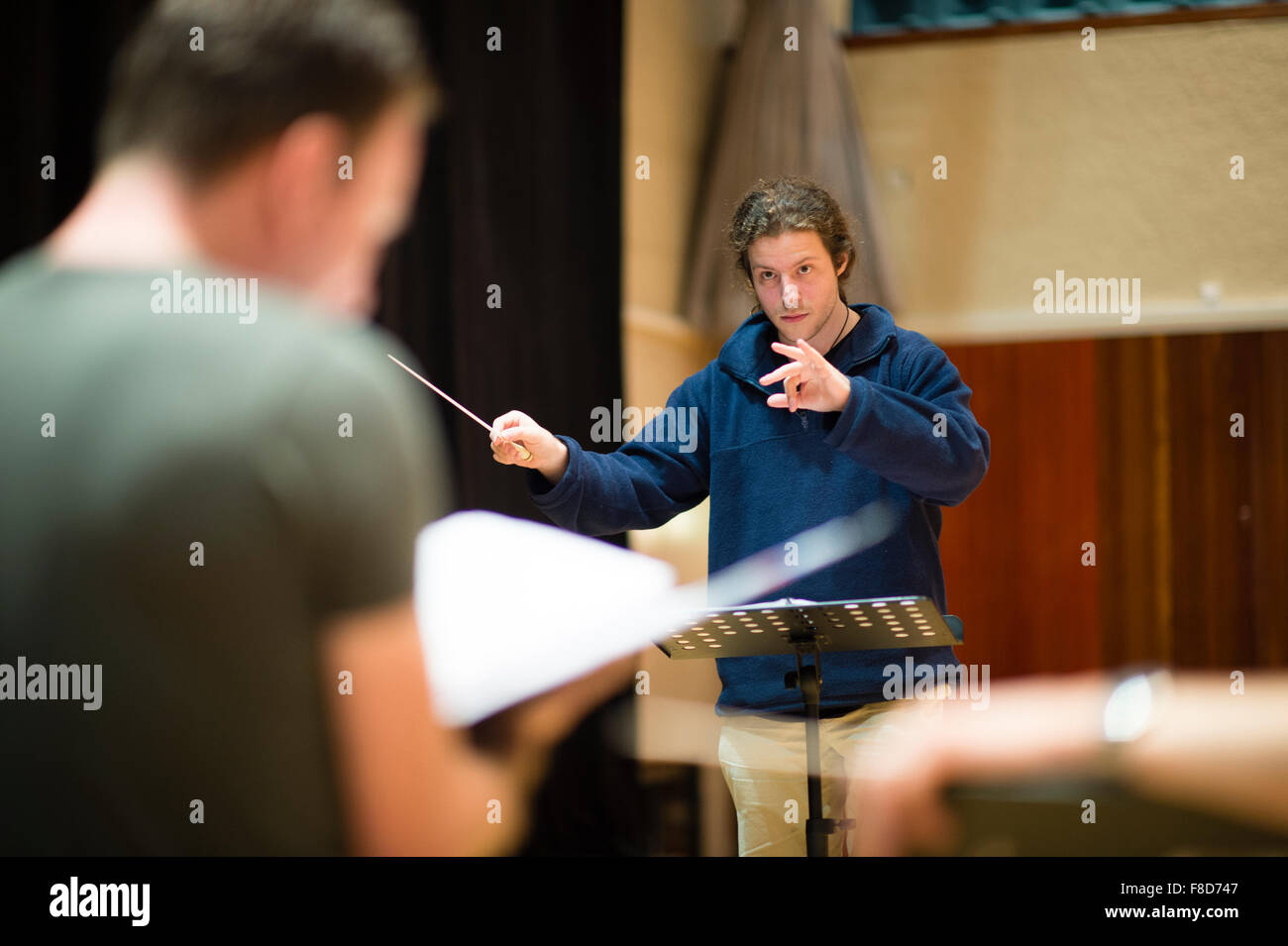 Music education: A young male conductor in a conducting masterclass  taught and led  by Toby Purser at Aber Music Fest music festival 2015 Stock Photo
