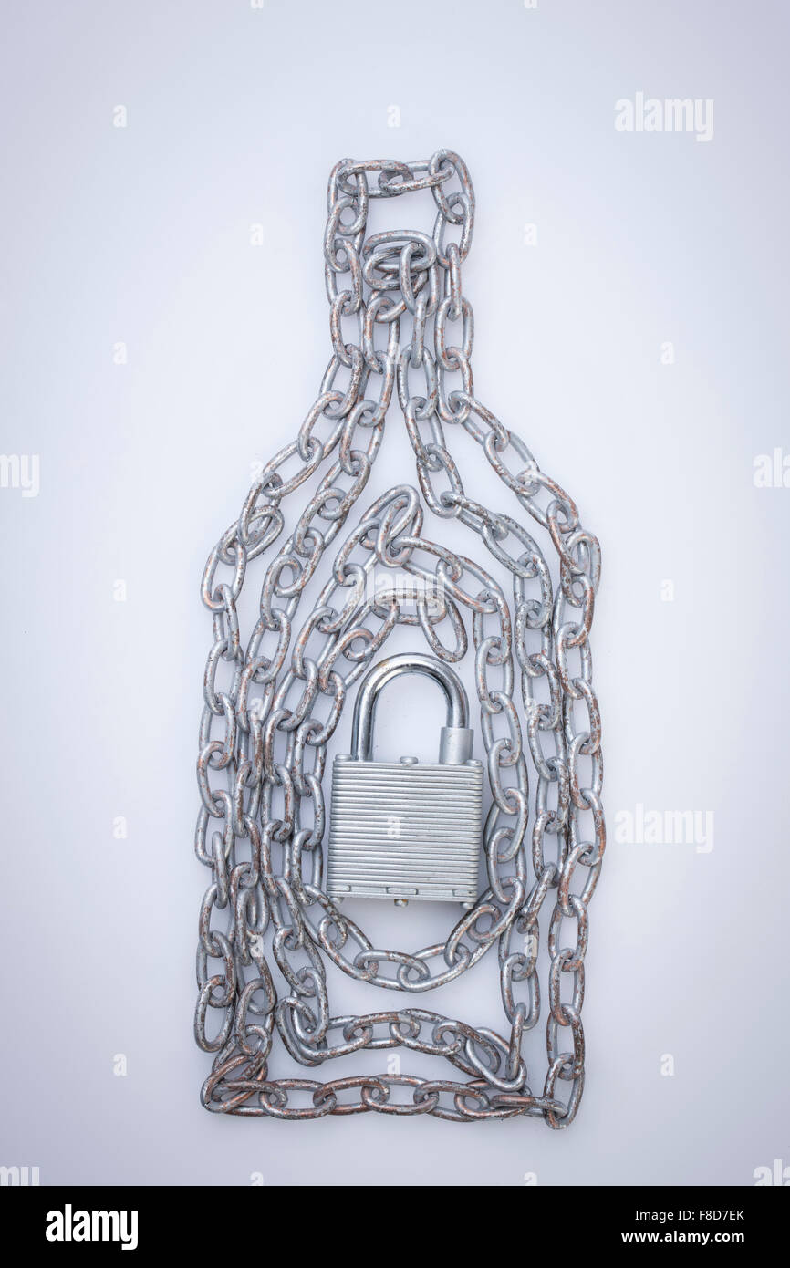 Chains twined into a bottle shape and a lock in the middle of it Stock Photo
