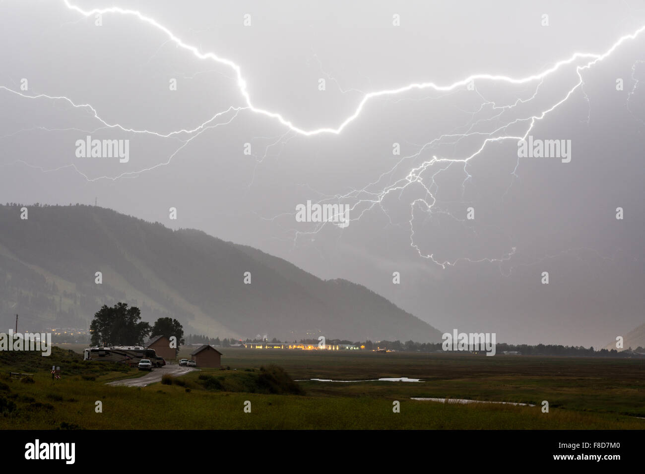 A lightning bolt streaking across the night sky above Snow King, National Elk Refuge, Wyoming Stock Photo