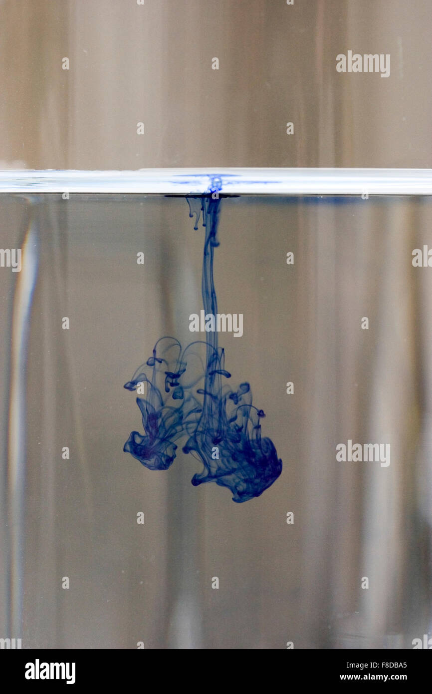 Drop of blue dye diffusing through water. Number three of four in diffusion series. Stock Photo
