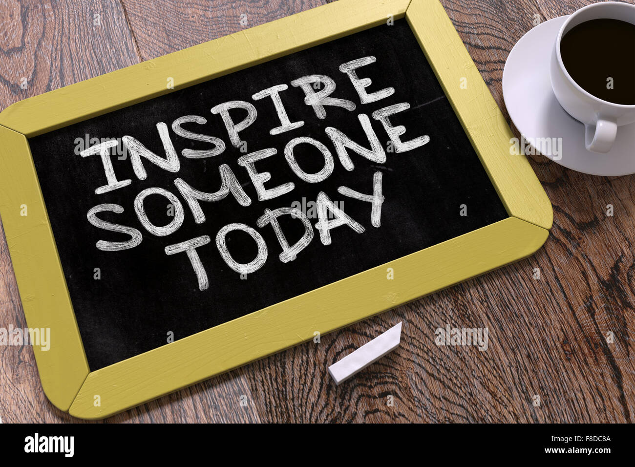 Inspire Someone Today on Chalkboard. Stock Photo