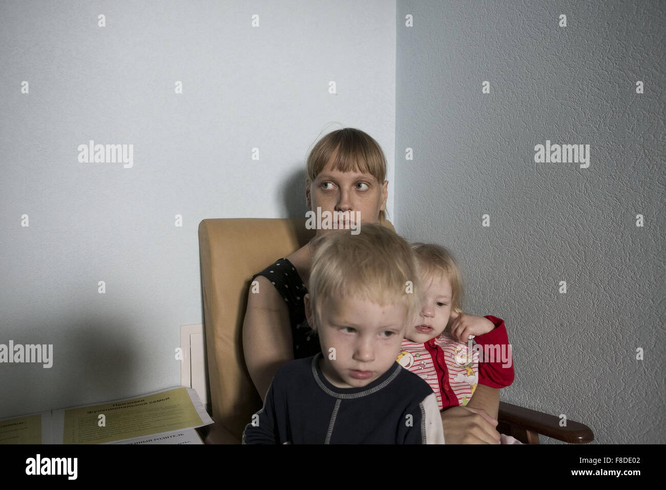June 10, 2015 - Tomsk, Western Siberia, Russia - A mother with her children attending a psicological consulting meeting at the Family Center opened in 2000. Two psicologists look after them. Single and divorced women with their husbands, addicted to alcohol or jobless, attend the Family center. Women do not have a higher education. The educational attainment level of the household head is strongly correlated with poverty. Caritas provides used clothes and food to them.They do the shopping with the mothers to teach them how to save up. Some single women work, others have a steady job with a low Stock Photo