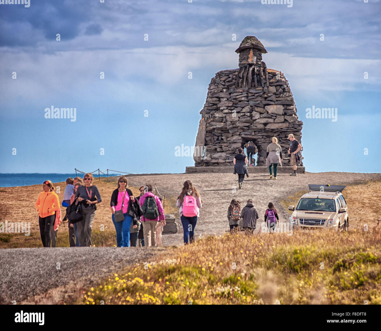 Arnarstapi, Snaefellsnes Peninsula, Iceland. 30th July, 2015. A group of tourists visit the huge stone structure of Bardur SnaefellsÃ¡s at Arnarstapi on the Snaefellsnes peninsula in West Iceland. By sculptor Ragnar Kjartansson, it relates to a late Icelander saga with legendary elements dating to the early 14th century. It is a favorite tourist destination. © Arnold Drapkin/ZUMA Wire/Alamy Live News Stock Photo