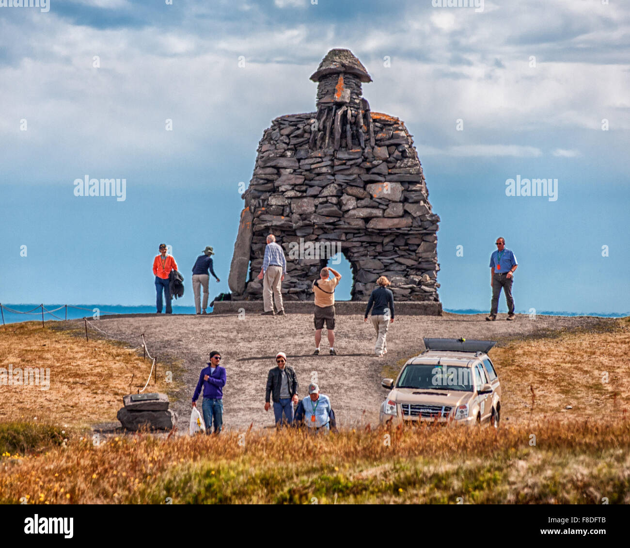 Arnarstapi, Snaefellsnes Peninsula, Iceland. 30th July, 2015. A group of tourists visit the huge stone structure of Bardur SnaefellsÃ¡s at Arnarstapi on the Snaefellsnes peninsula in West Iceland. By sculptor Ragnar Kjartansson, it relates to a late Icelander saga with legendary elements dating to the early 14th century. It is a favorite tourist destination. © Arnold Drapkin/ZUMA Wire/Alamy Live News Stock Photo
