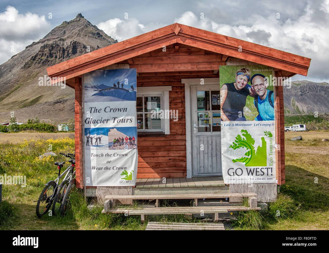 Snaefellsnes Peninsula, Iceland. 30th July, 2015. A wooden cabin with posters advertising tours of Iceland beneath the pyramidal shaped Mt. Stapafell volcano in Arnarstapi, West Iceland, on the Snaefellsnes Peninsula.Iceland has become a favorite tourist destination. © Arnold Drapkin/ZUMA Wire/Alamy Live News Stock Photo