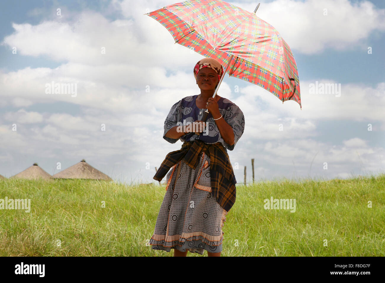 South African woman holding an umbrella  to protect her from the sun Stock Photo