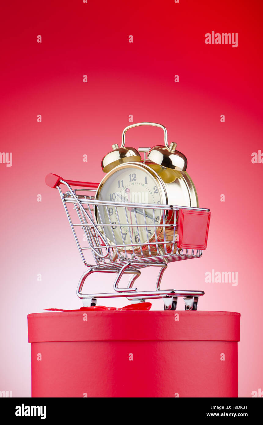 Buying time concept with clock and shopping cart Stock Photo - Alamy