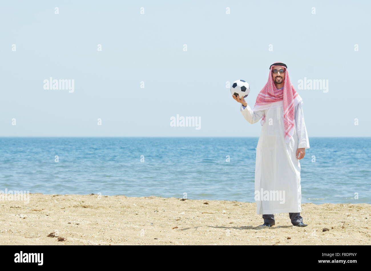Man holding soccer ball seaside hi-res stock photography and images - Alamy