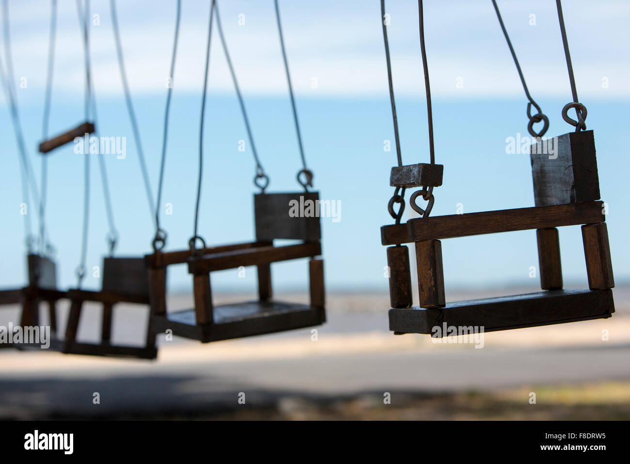 Empty swings in a children play area at park Stock Photo