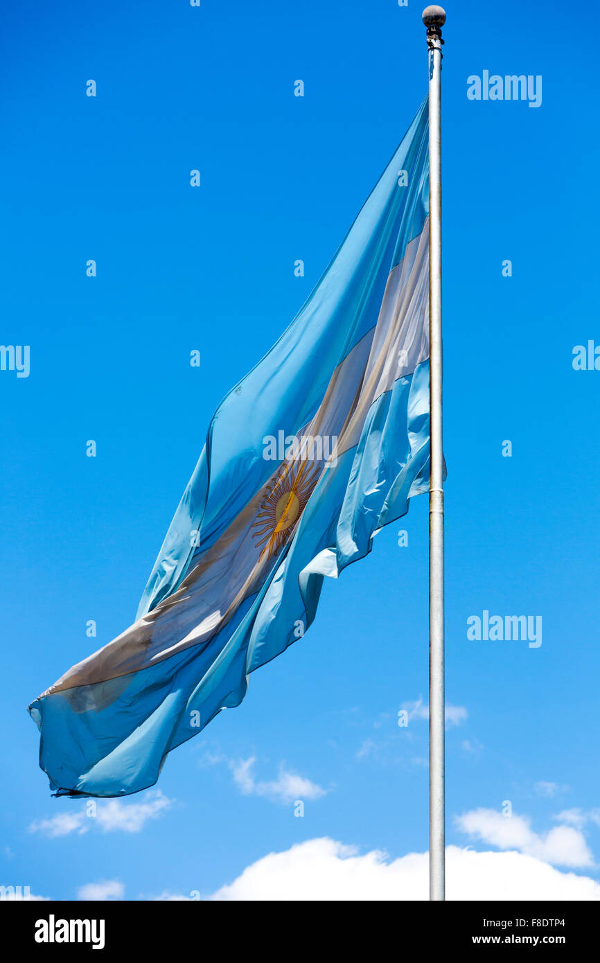 Flag of Argentina flying against a blue sky. Stock Photo