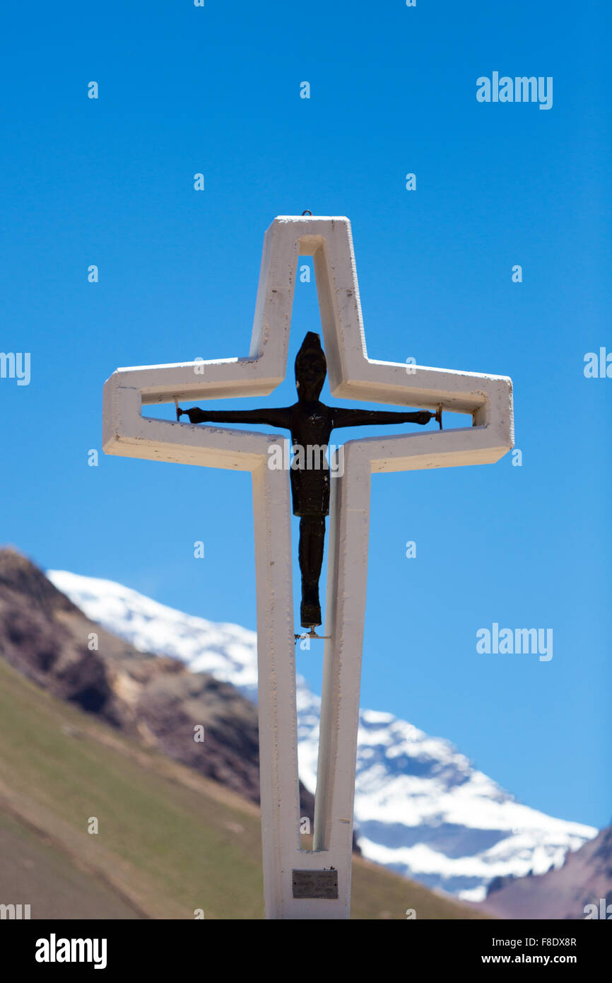 Religious cross with Aconcagua peak. Argentina Stock Photo