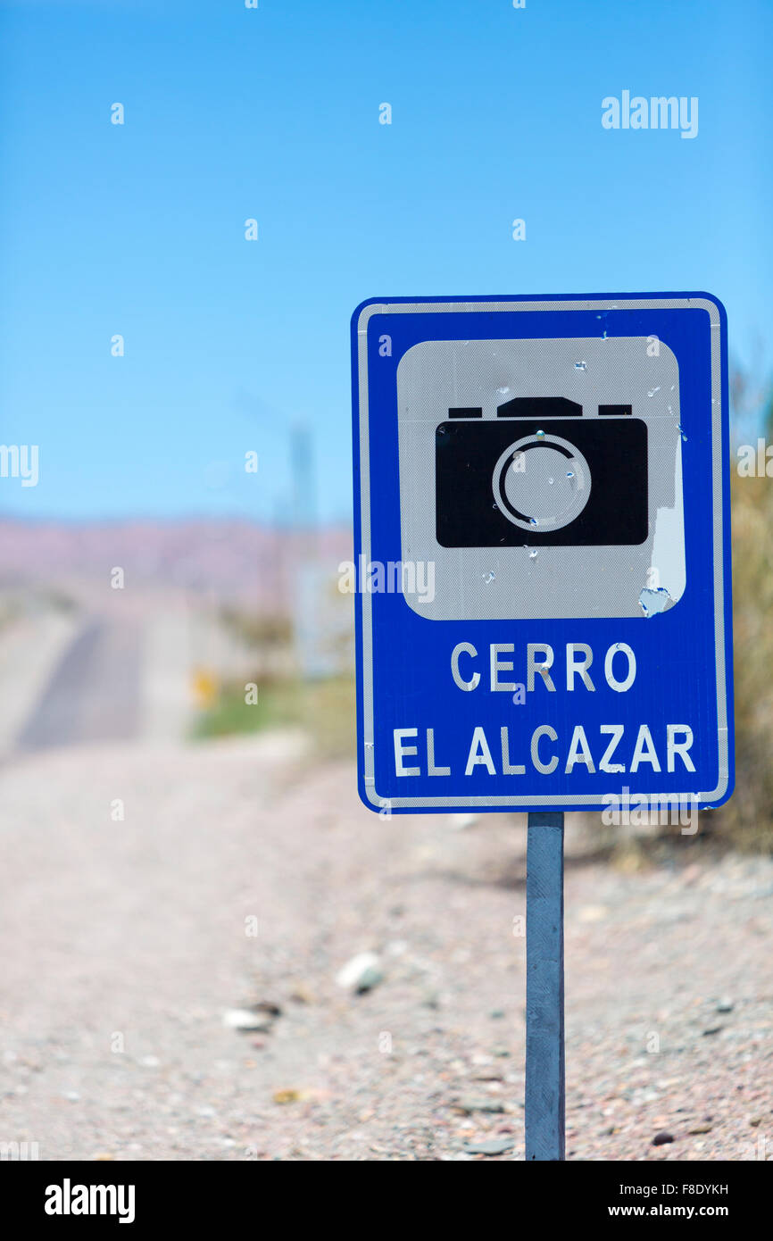 Photo road with sign pole and blue sky at the El Alcazar pass along the ruta 40 (Route 40) in San Juan Province. Argentina Stock Photo
