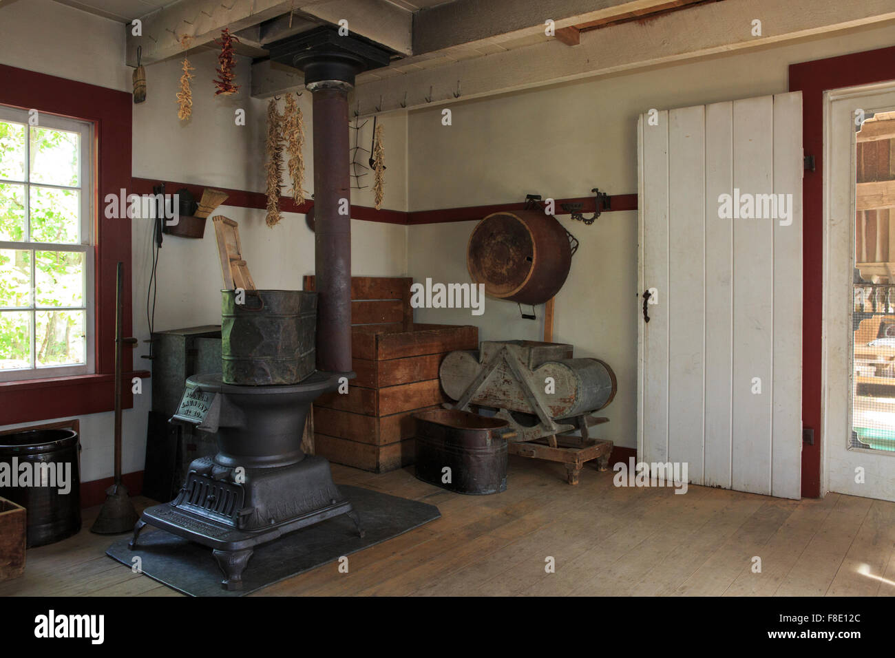 Large room in an old farmhouse, with a cast iron stove and stored supplies. Stock Photo
