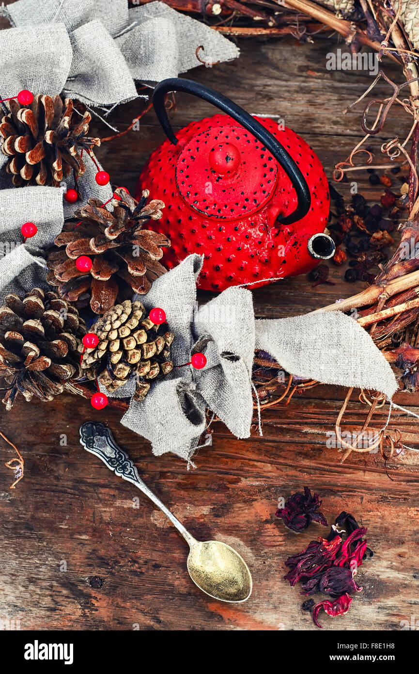 Retro red cast iron kettle and cane wreath with cones Stock Photo Alamy