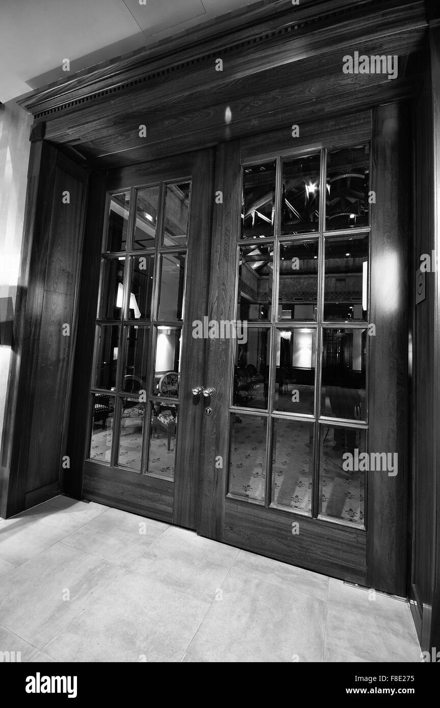 big massive luxury wood door in hotel restaurant caffee Stock Photo