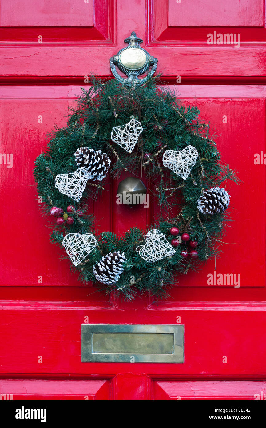 Christmas wreath on a red coloured wooden door Stock Photo