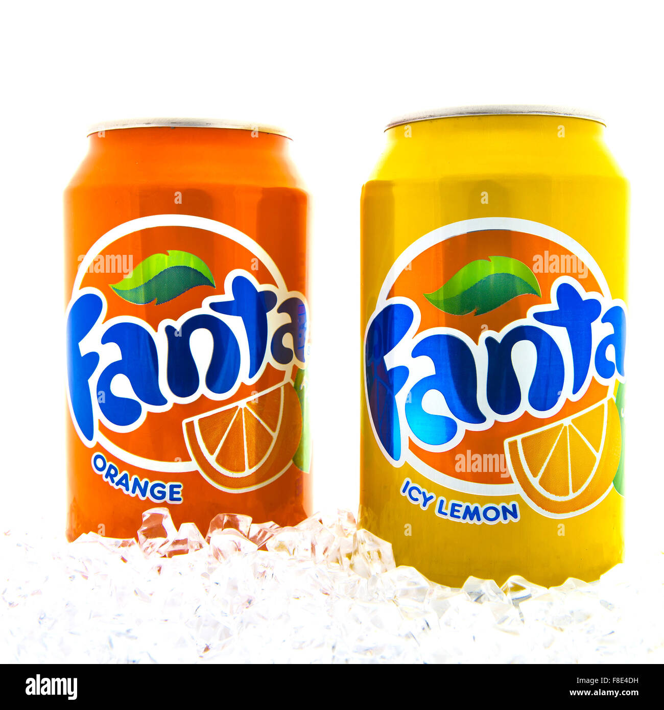 Two Cans of Fanta drink on ice over a white background Stock Photo
