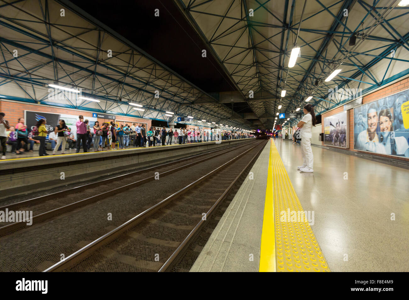 Medellin metro station with railway tracks and people, Colombia Stock Photo