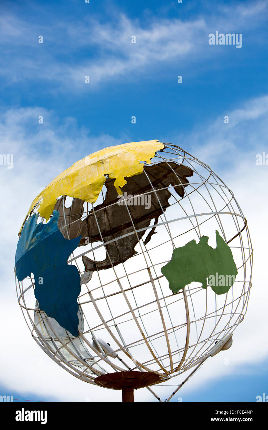 Metal sculptured globe of the planet earth against a cloudy blue sky. Tupiza. Blovia Stock Photo