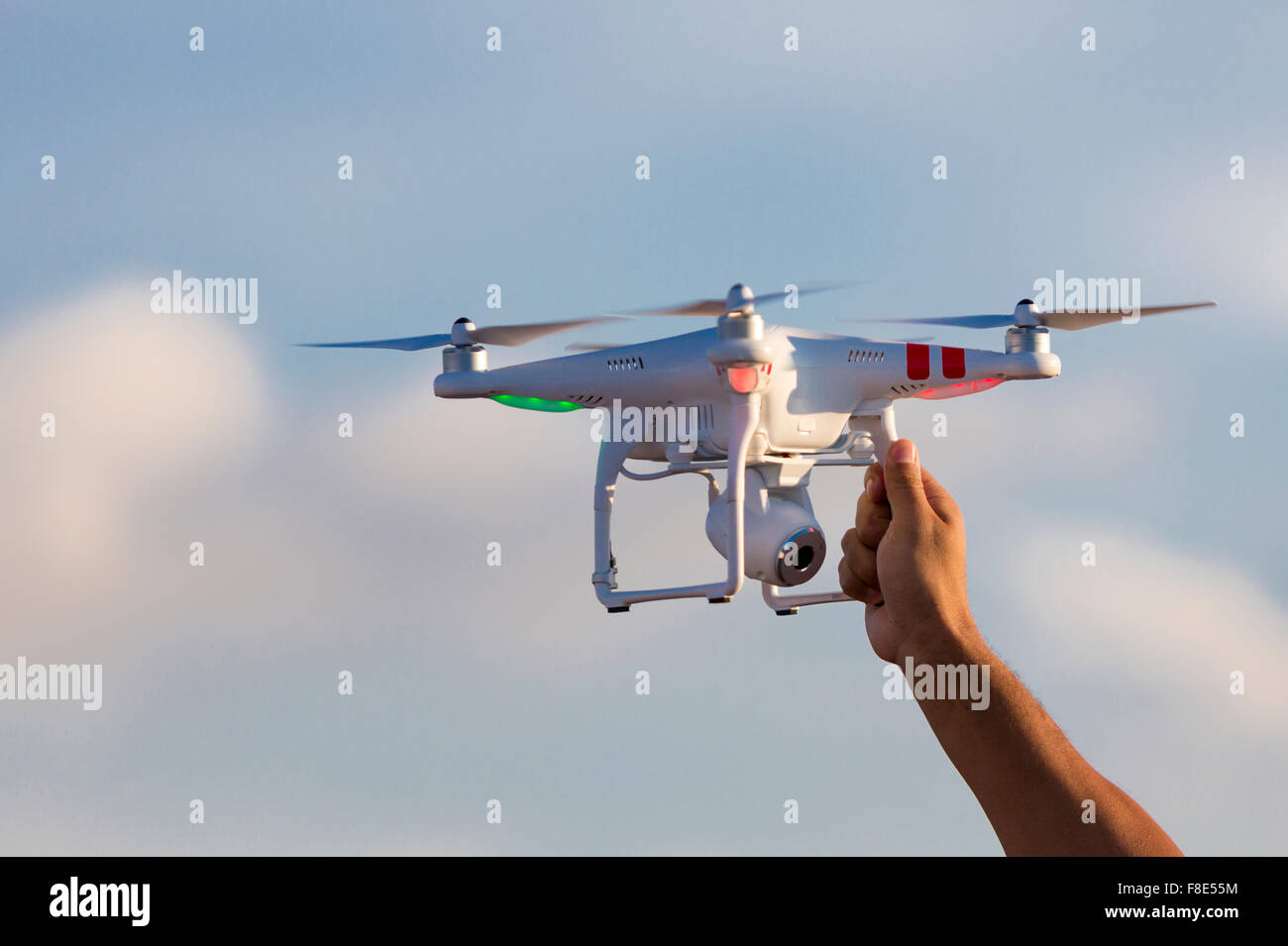 Flying radio controlled DJI Phantom quadcopter drone with video camera  landing and ready to be catch by man hand. Colombia 2015 Stock Photo - Alamy