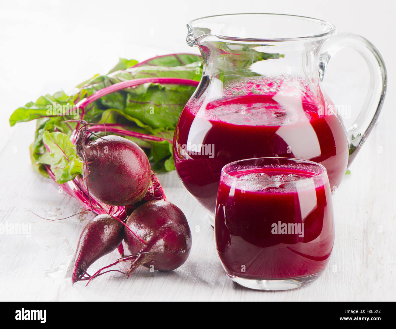 Beetroot juice and bunch of fresh beetroots with leaves. Selective