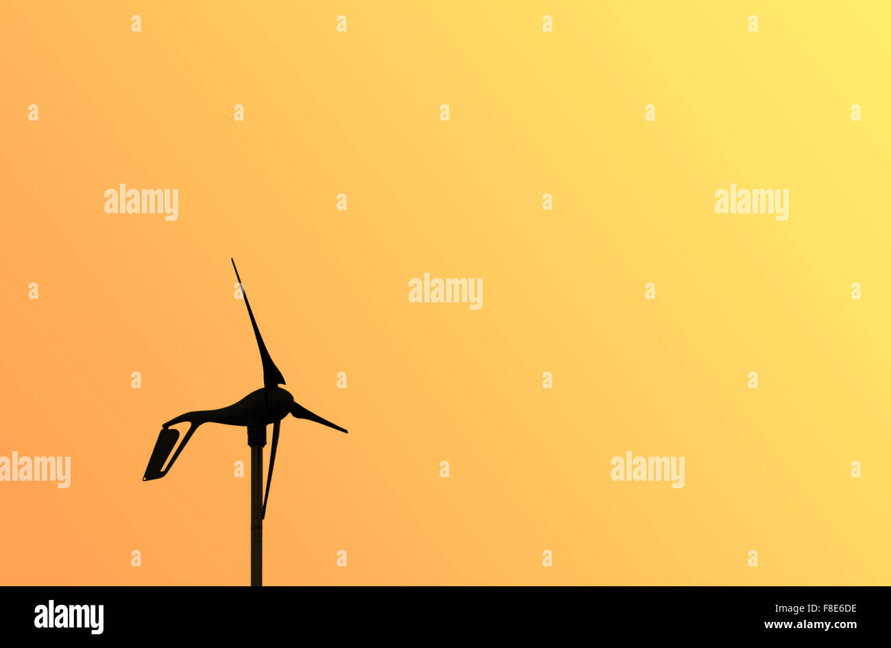 Wind generator turbine propellers against yellow background Stock Photo
