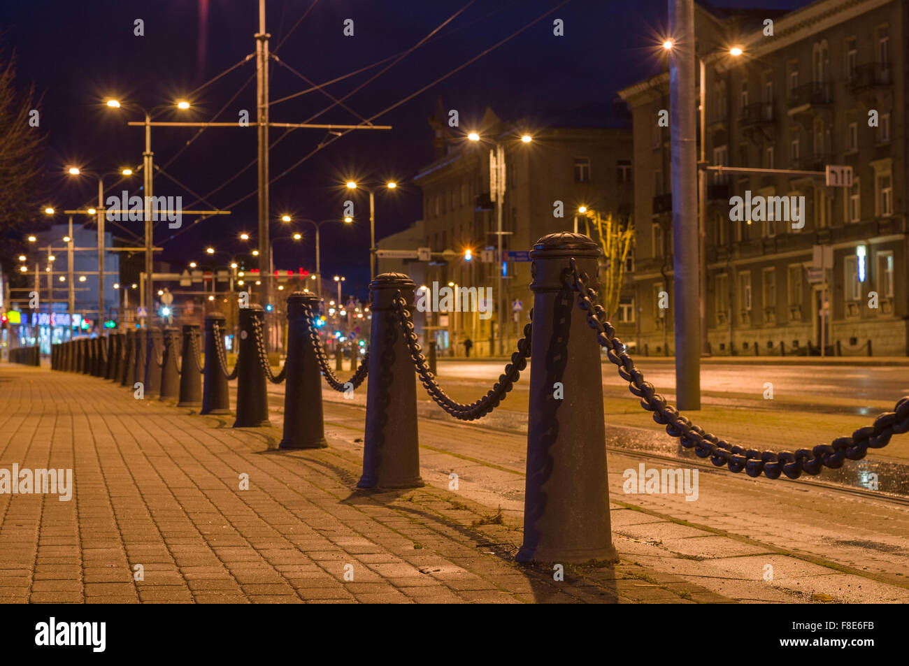 Perspective view of decorative poles and chain, night urban background Stock Photo