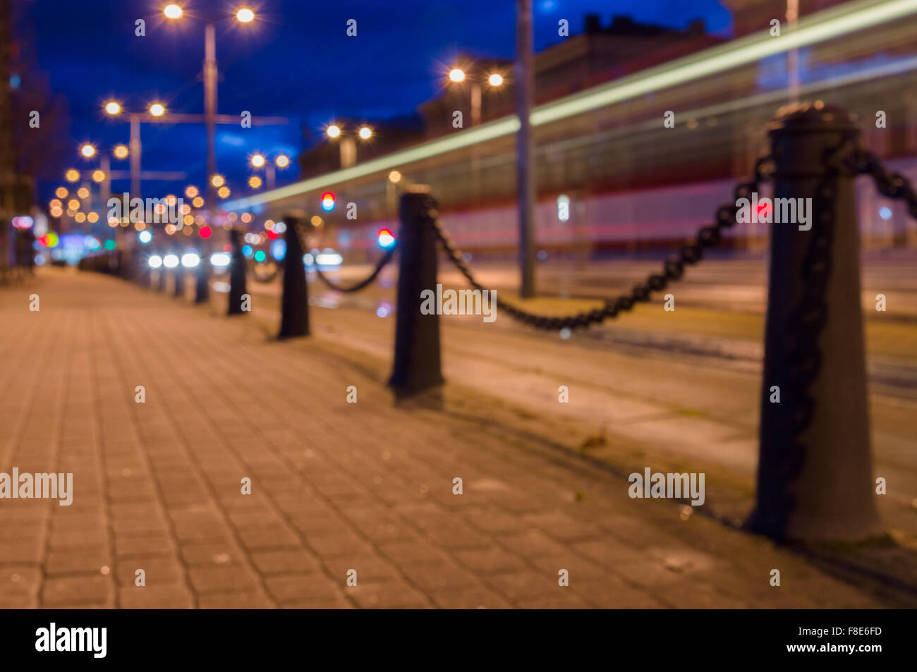 Trail of light left by tram, night city blurred image Stock Photo