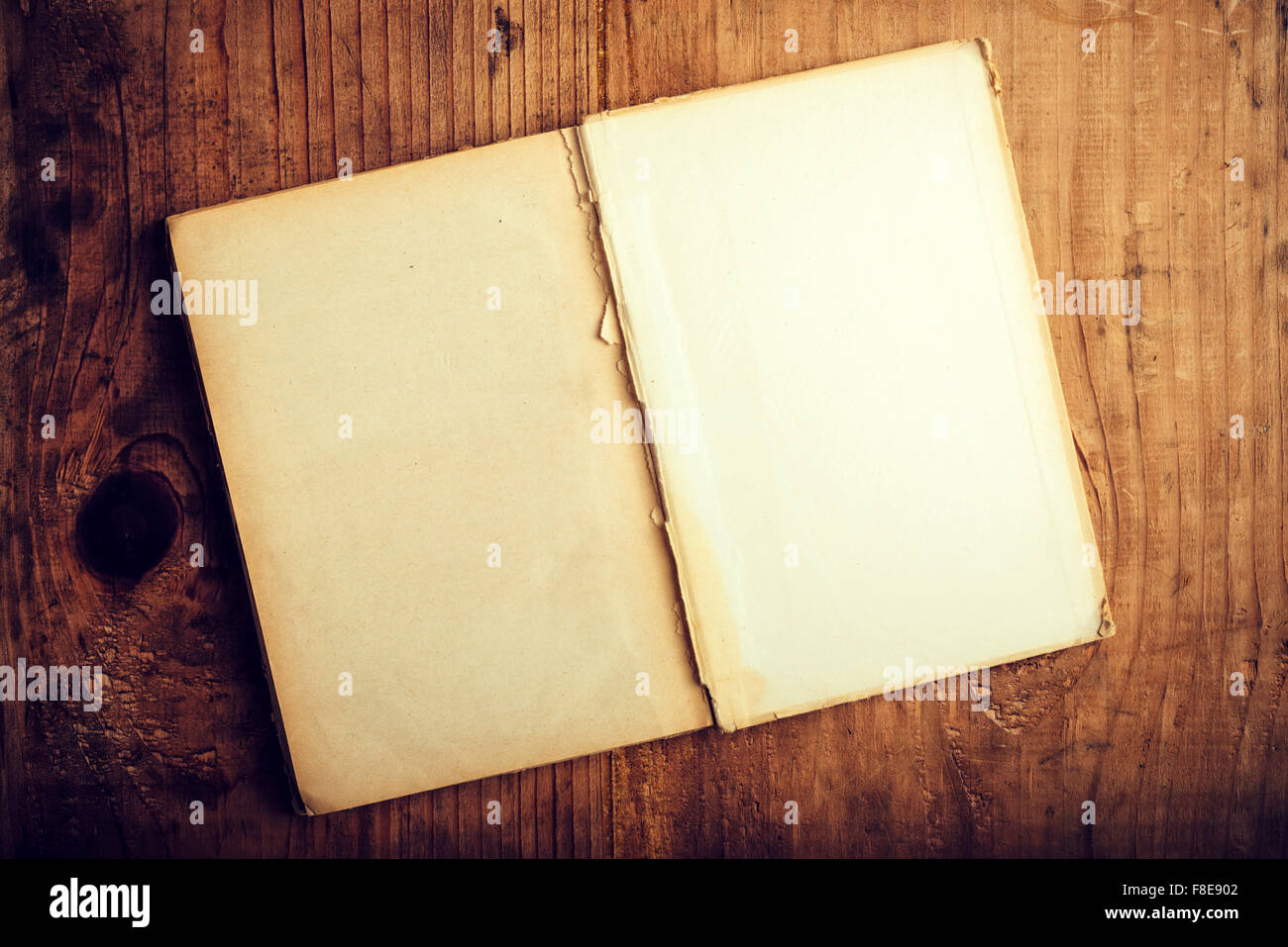 Top View Of Old Open Book With Blank Pages On Wooden Desk As Copy