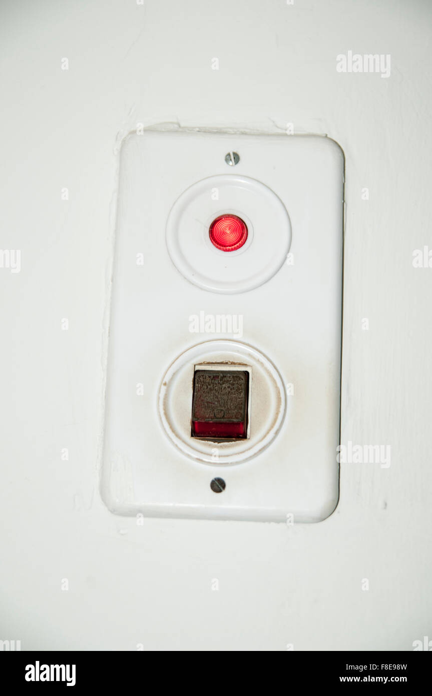 Light switch with red pilot light on a wall Stock Photo Alamy