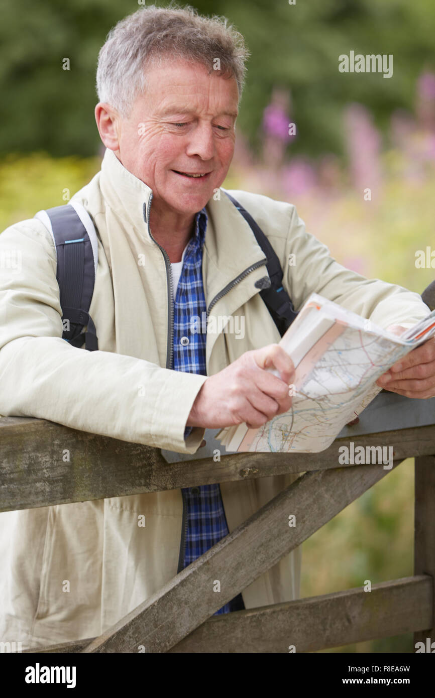Senior Man Hiking In Countryside Stock Photo