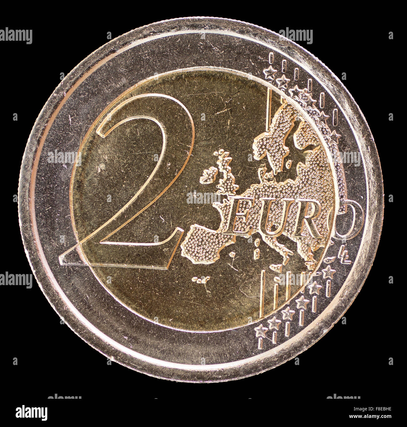 Common side of two euro coin isolated on a black background. The reverse face displays a map of Europe and was designed by Luc L Stock Photo