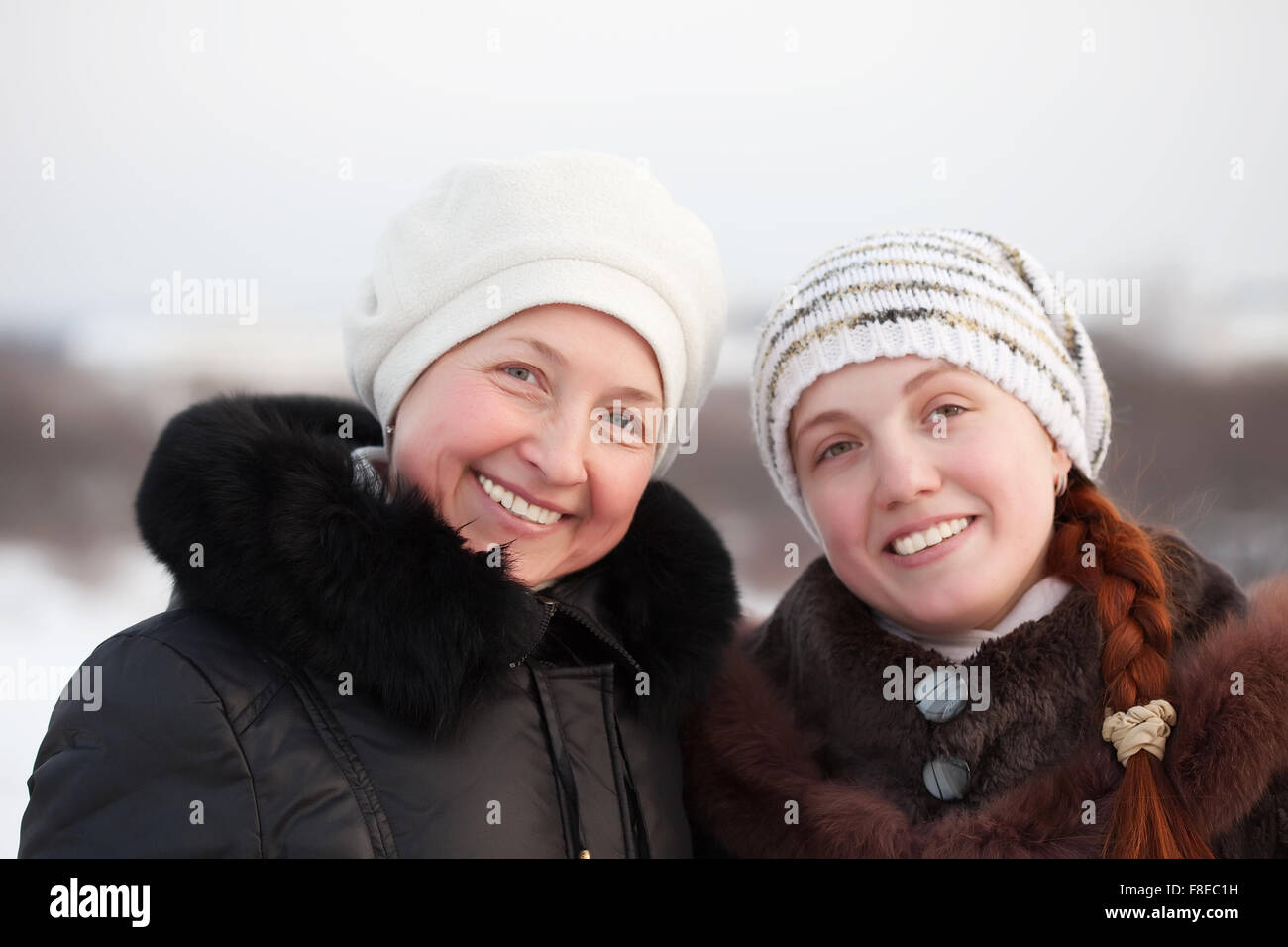 Portrait of two happy women in winter park Stock Photo - Alamy