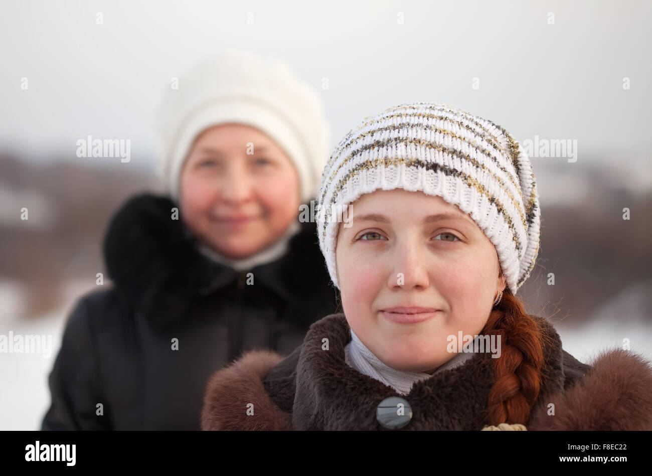 Portrait of two women in winter park Stock Photo - Alamy