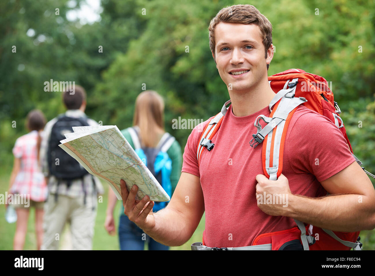 Happy young friends map hi-res stock photography and images - Alamy