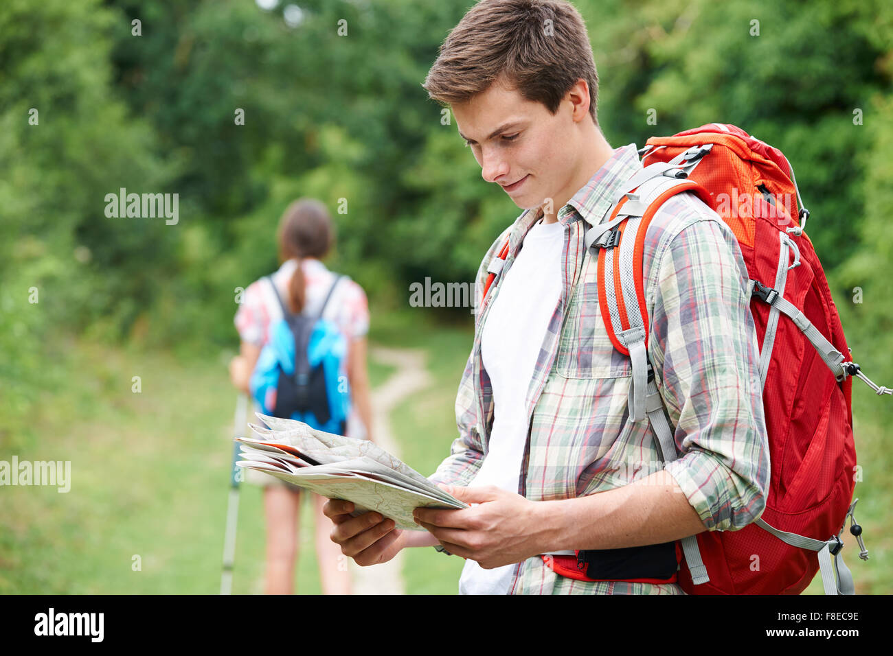 Young Couple Hiking In Countryside Stock Photo