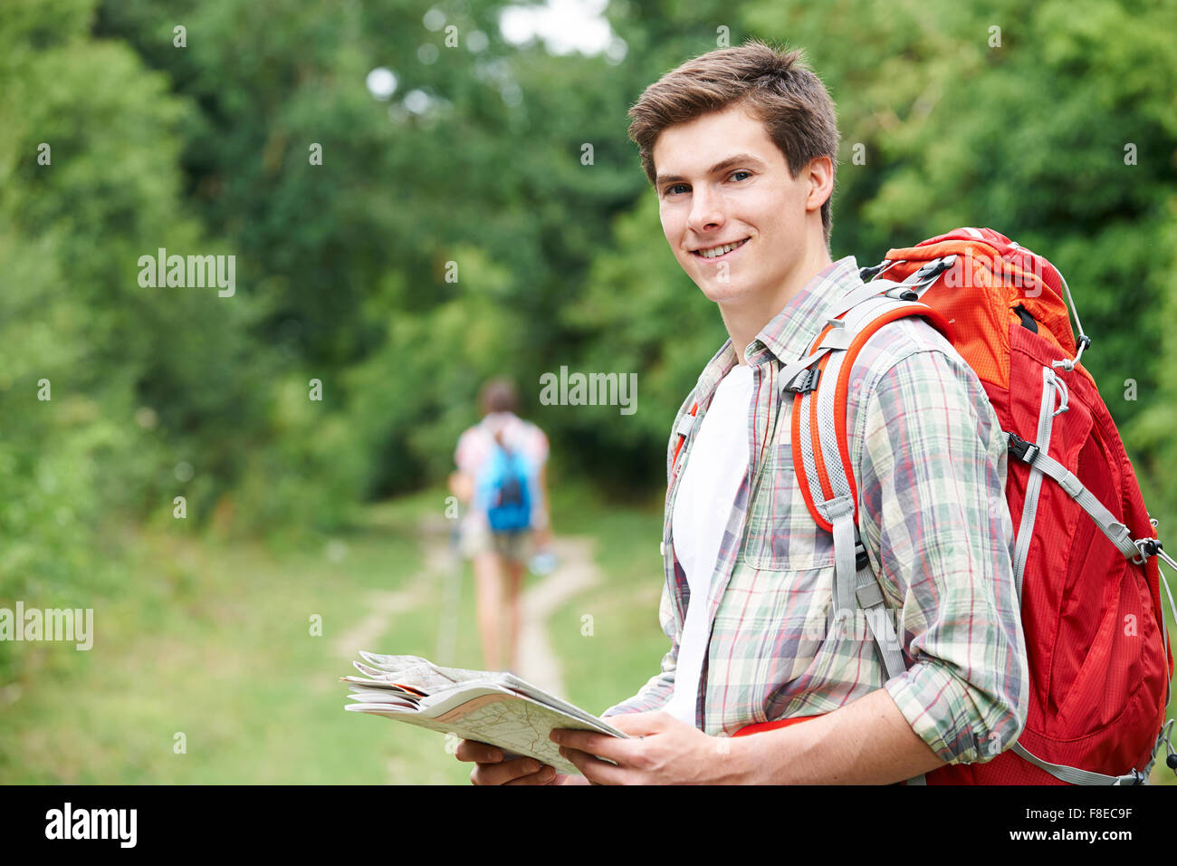 Young Couple Hiking In Countryside Stock Photo