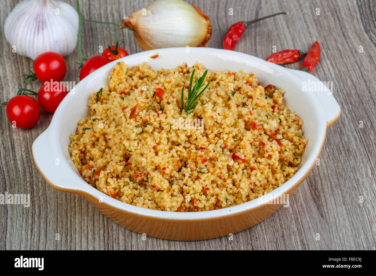 Arabic traditional cuisine Couscous with tomato and green onion Stock